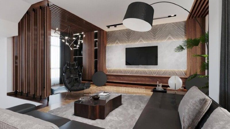 Là một trong những ý tưởng thiết kế nội thất phòng khách biệt thự sang trong được thiết kế theo lối hiện đại nhưng lại sử dụng chất liệu gỗ làm chủ đạo đã tạo nên vẻ đẹp độc đáo, mới lạ trong Vinhomes Imperia Hải Phòng. Gỗ được biến hóa đa dạng nhưng lại mang tính liền mạch, từ chất liệu làm kệ trang trí, gỗ ốp tường, tạo điểm nhấn đến kệ trang trí. Tuy nhiên không làm cho không gian bị trầm, bởi sự kết hợp khéo léo khi sử dụng chất liệu đá ốp tường có độ bóng sang cùng gam màu tương phản, kết hợp cùng màu đơn sắc trần thạch cao đã làm không gian như trở thành bức tranh hài hòa nhưng lại cuốn hút không ngờ.